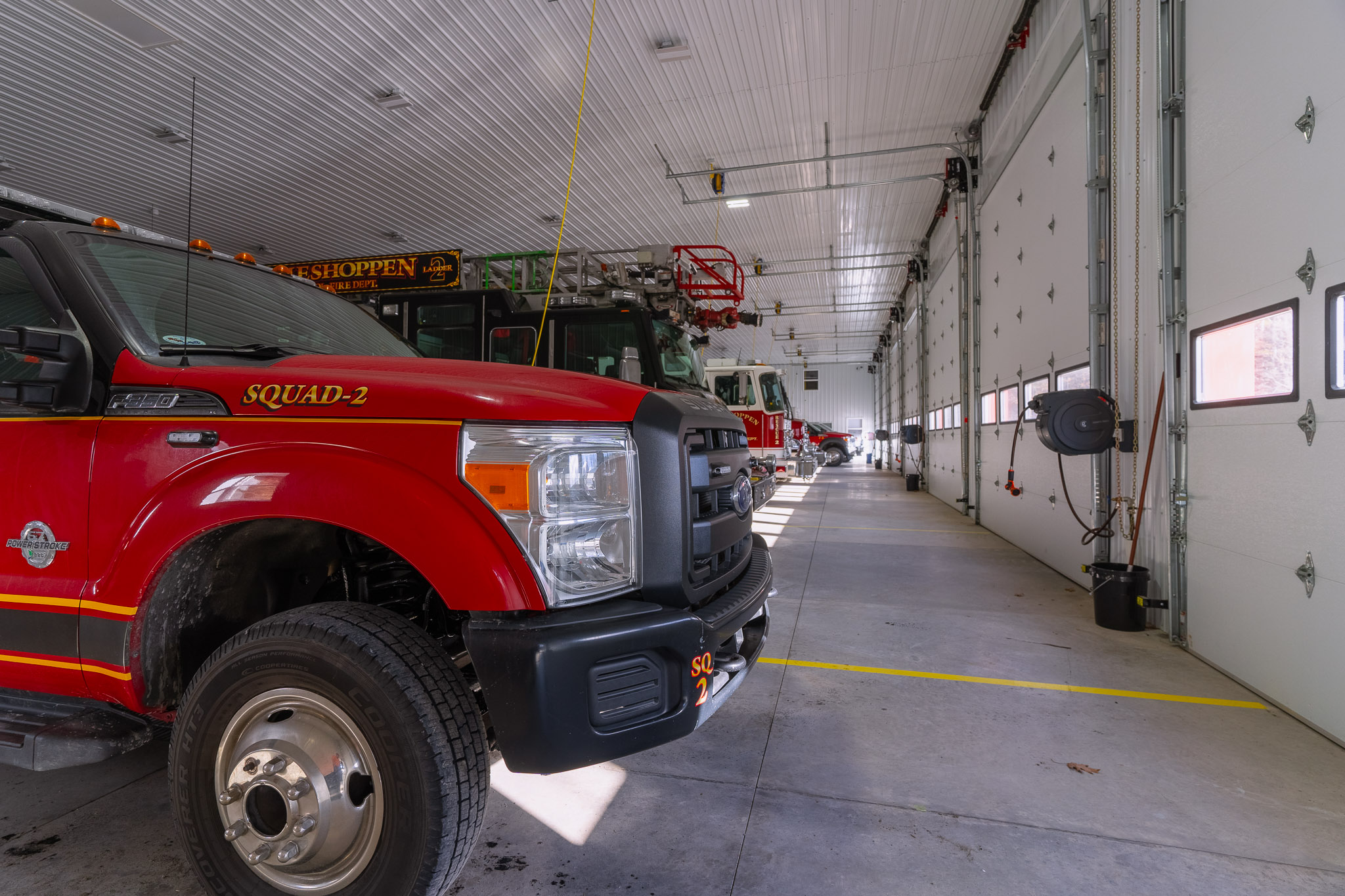 White insulated windows and man doors with flush panel finish in fire department pole barn