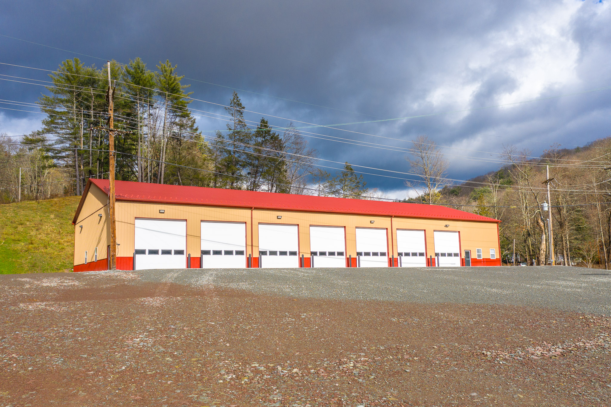 Meshoppen Fire Department pole barn with red metal roof and tan siding built by Pioneer Building"